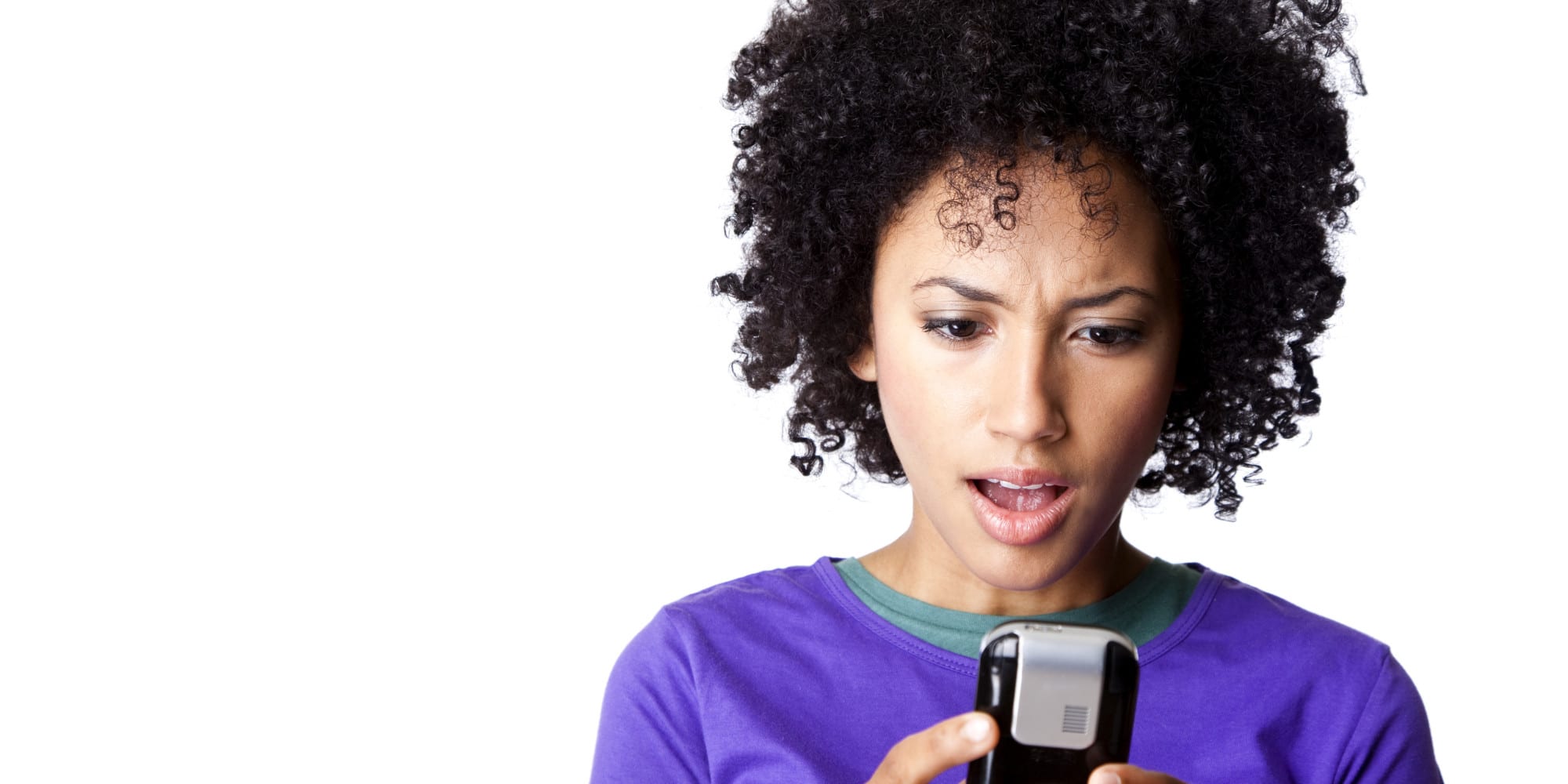 pretty young woman looking surprised at her text message