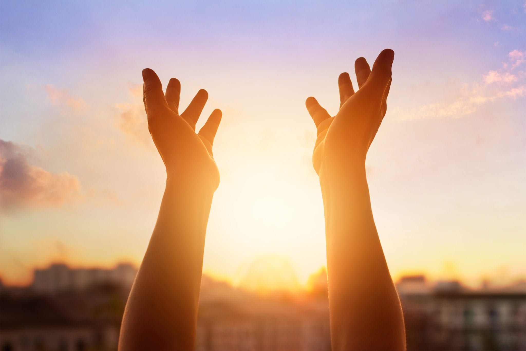 Respect and pray on the sunset in city background