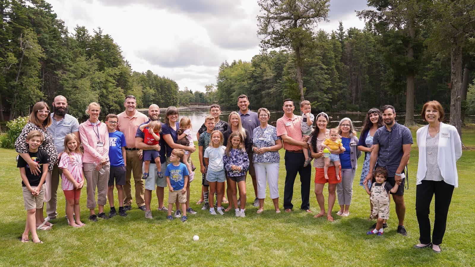 A group of individuals on a corporate retreat, smiling at the camera near philadelphia